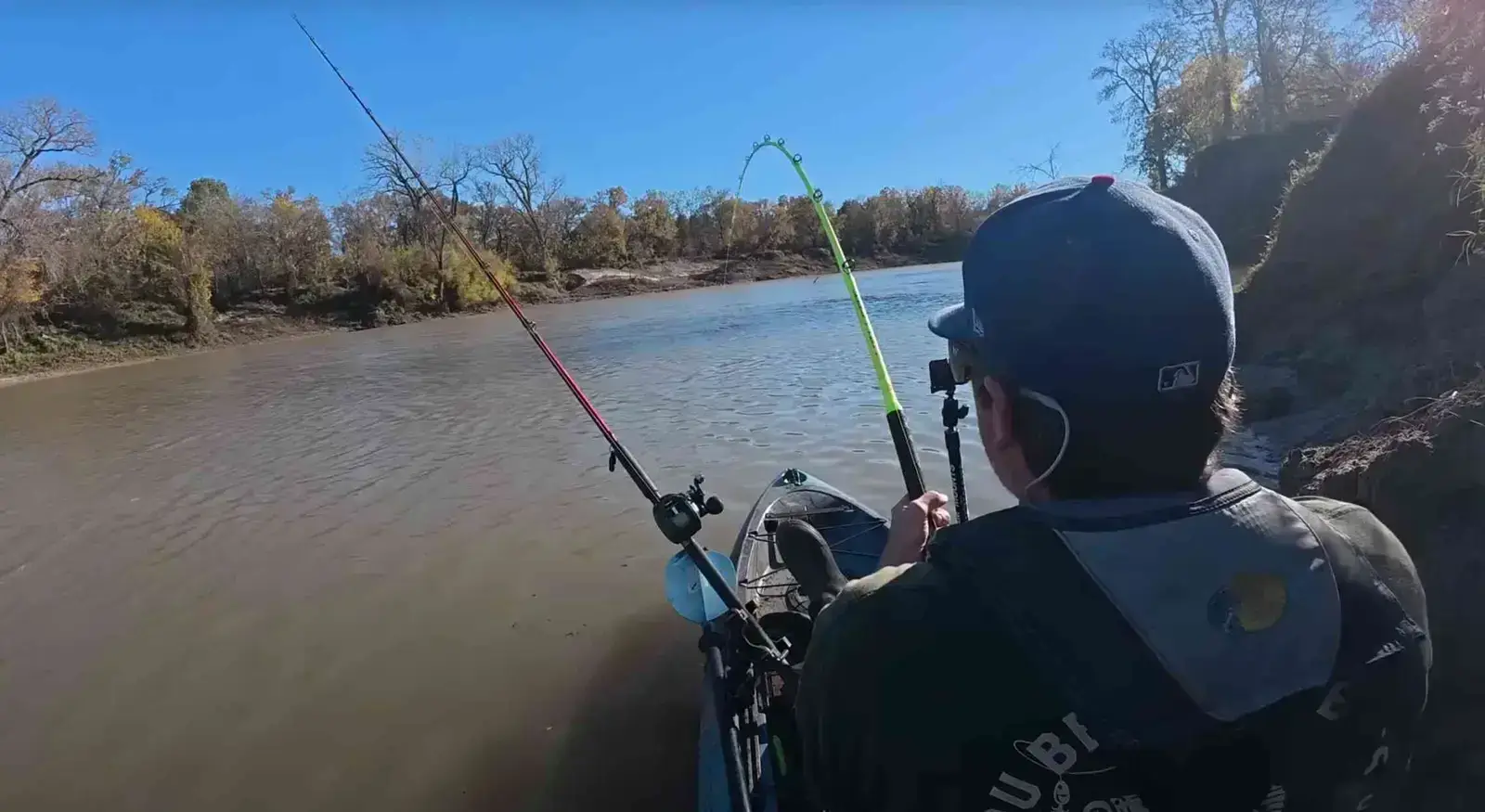 Spencer Bauer hooks into a fish as his Hellcat rod bends sharply on a fast-flowing winter river.