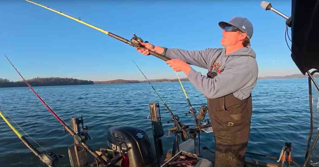 Spencer Bauer hurls a fresh cut-bait rig, aiming to connect with feisty winter cats along a windless reservoir.