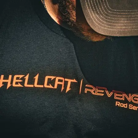 Close-up of Hellcat Revenge® T-shirt with bold orange logo on black fabric